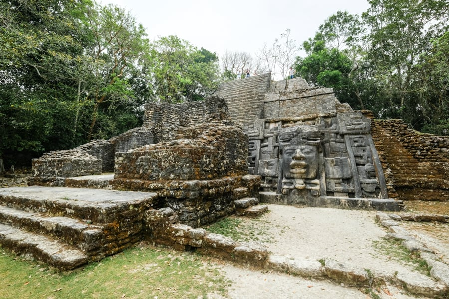 The Lamanai ruins, a vast ancient Mayan archaeological site in Belize, featuring towering pyramids, stone temples, and intricate carvings, surrounded by dense jungle and rich with historical significance.