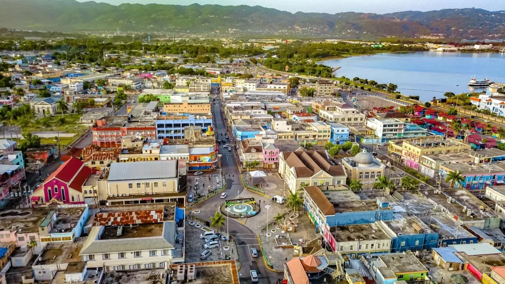 Panoramic view of Montego Bay featuring beaches, palm trees, and tropical landscapes, with tourists exploring the city on a guided tour